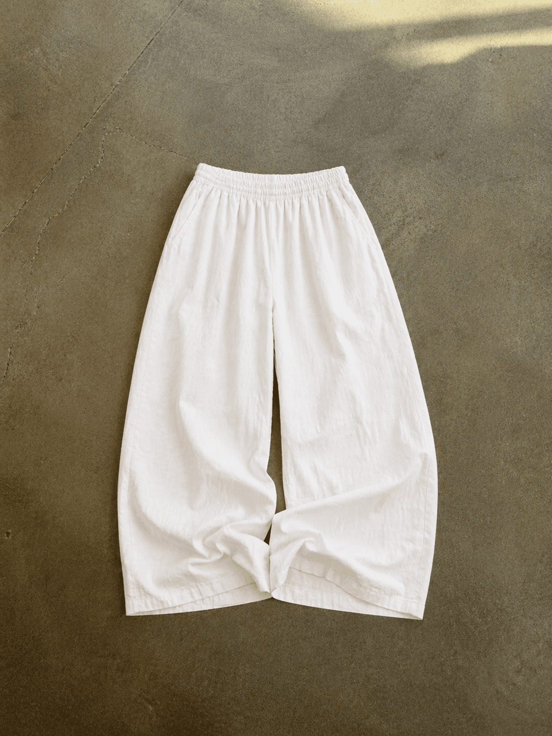 White pants on a textured brown surface