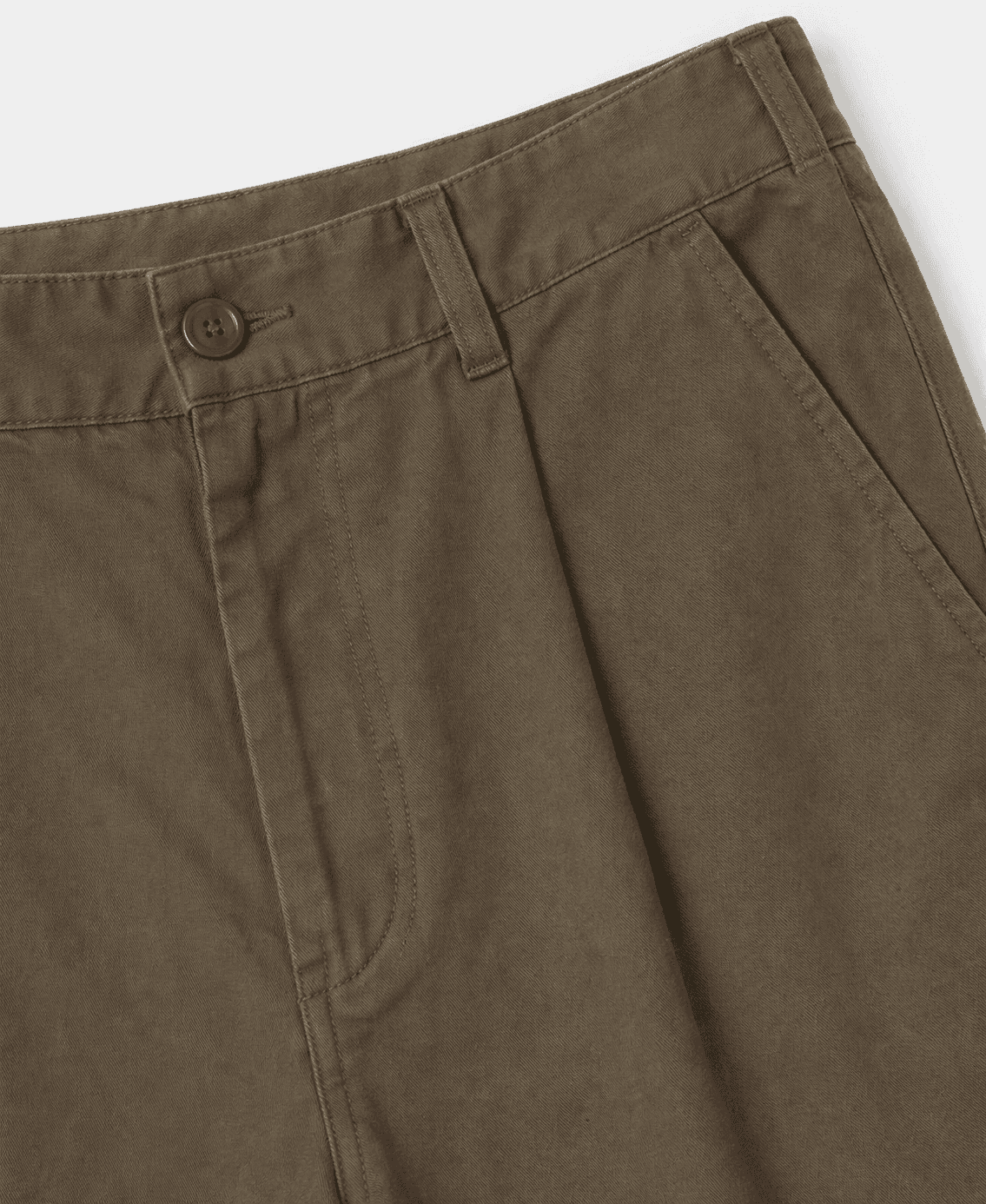 Close-up of brown pants with a button on a white background