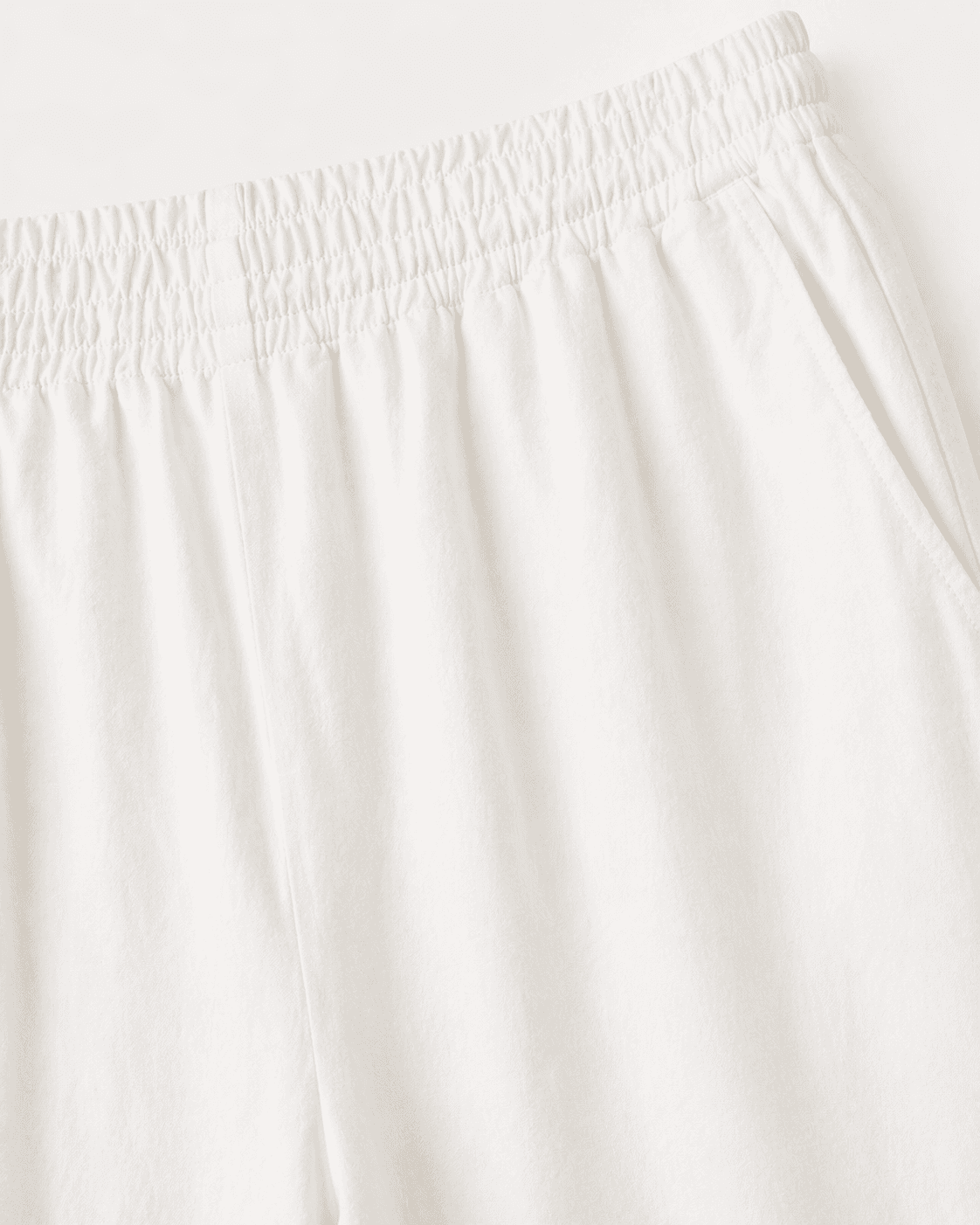Close-up of white pants with a plain background