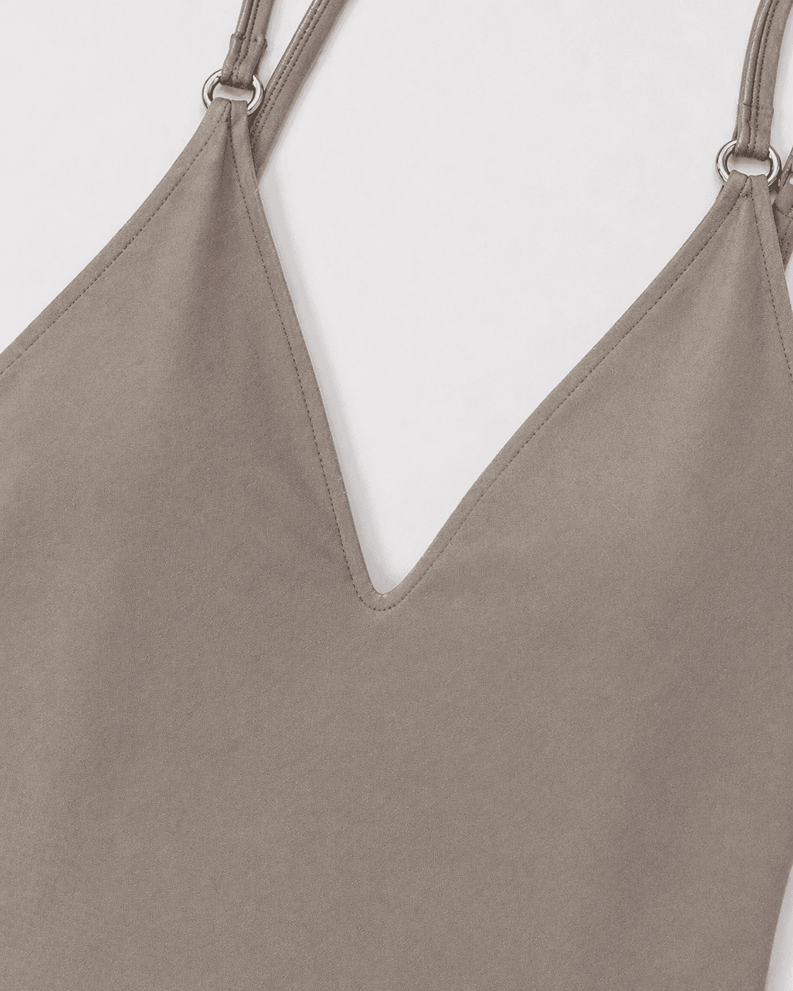 Close-up of a beige tank top with thin straps on a white background