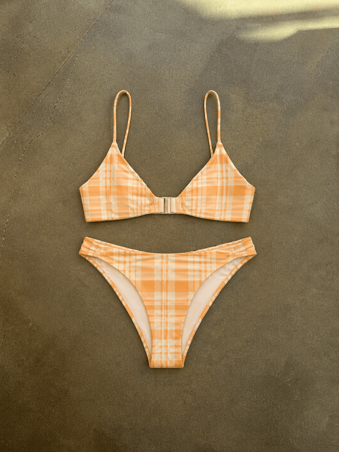 Plaid bikini set on a textured brown background