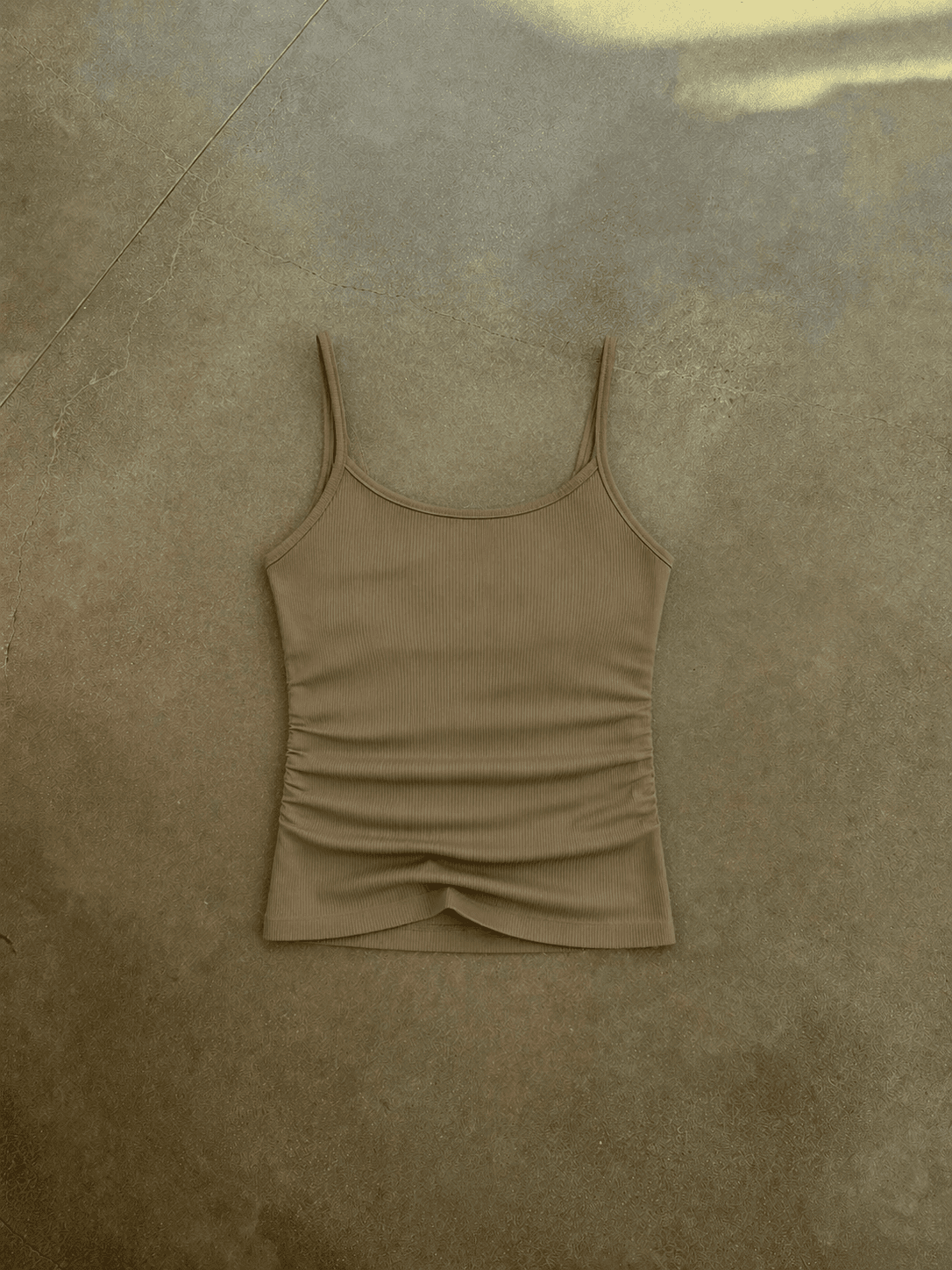 Beige tank top on a textured brown surface
